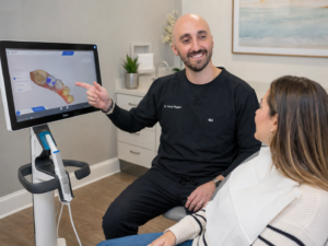 Dr. Vince Riggio reviewing a digital dental scan with a patient at Sunset Tower Family Dentistry