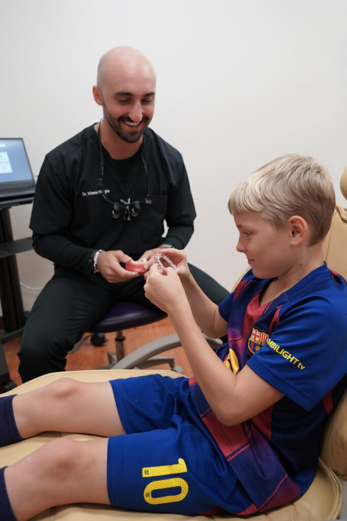 Dr Vince Riggio of Sunset Tower Family Dentistry in Sunset Hills, MO with child