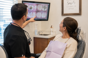Dentist reviewing older dental work with a patient during a routine dental evaluation.